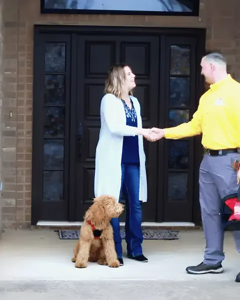 Uniformed technician greeting homeowner at the door, from Rub-A-Dub Plumbing’s own photographs.