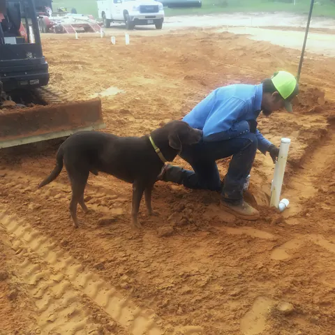 Technician setting rough-in on new pad, from Lee's Plumbing’s own photographs.