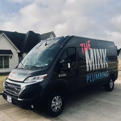 Branded The Mink Plumbing service van at a home, from The Mink Plumbing’s own photographs.