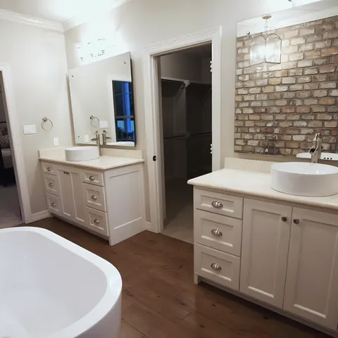 Residential master bath with freestanding tub and double vanity, from Watson Plumbing, Inc.’s own photographs.